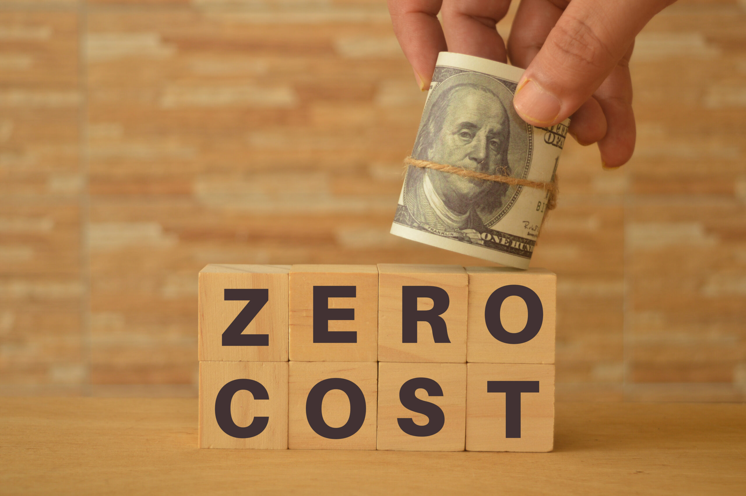 hand-holding-money-banknote-wooden-blocks-with-text-zero-cost-scaled.jpg