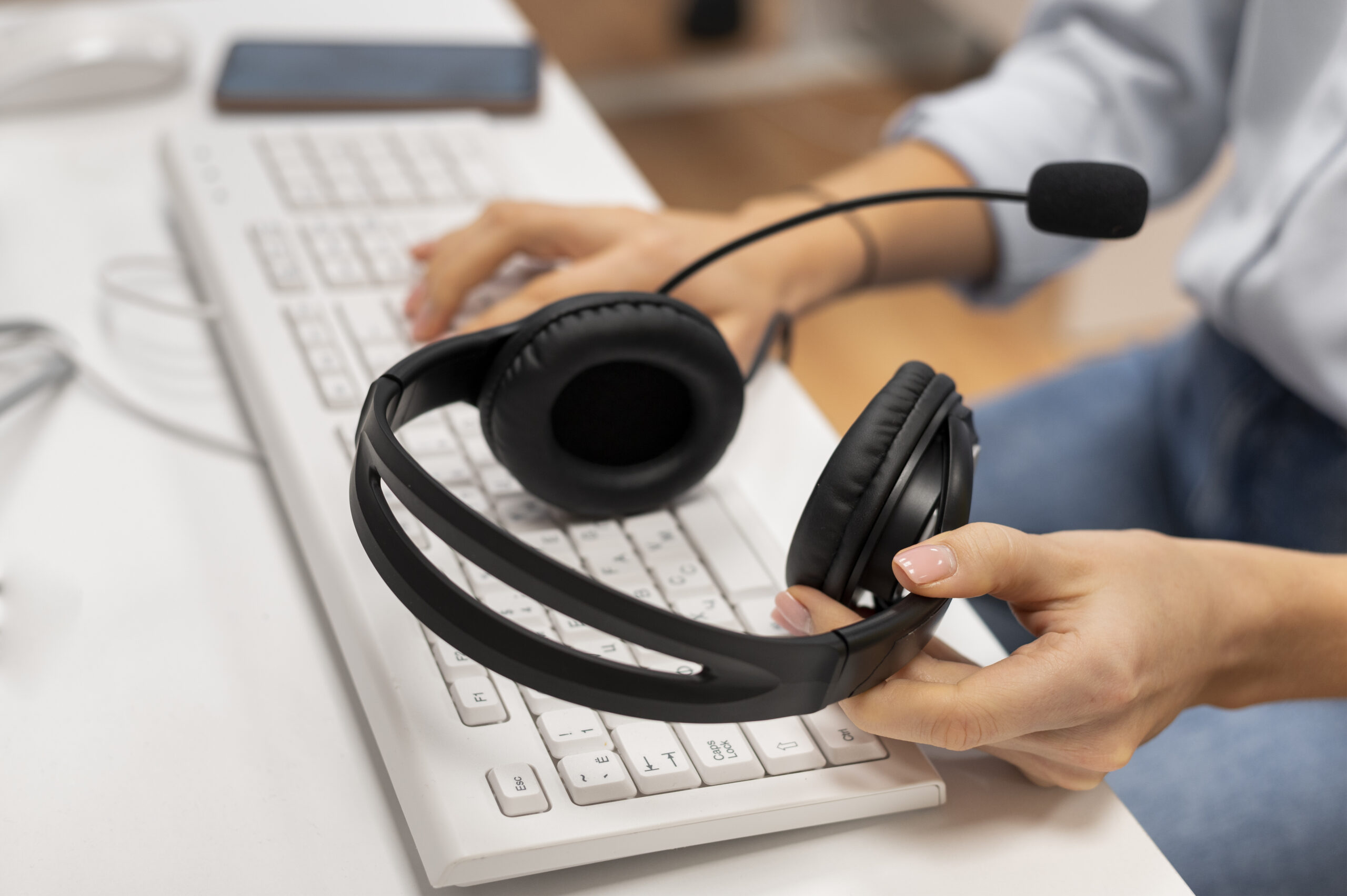 woman-working-call-center-holding-pair-headphones-scaled.jpg